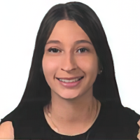 A woman with long, straight dark hair wearing a black top smiles at the camera against a plain white background.